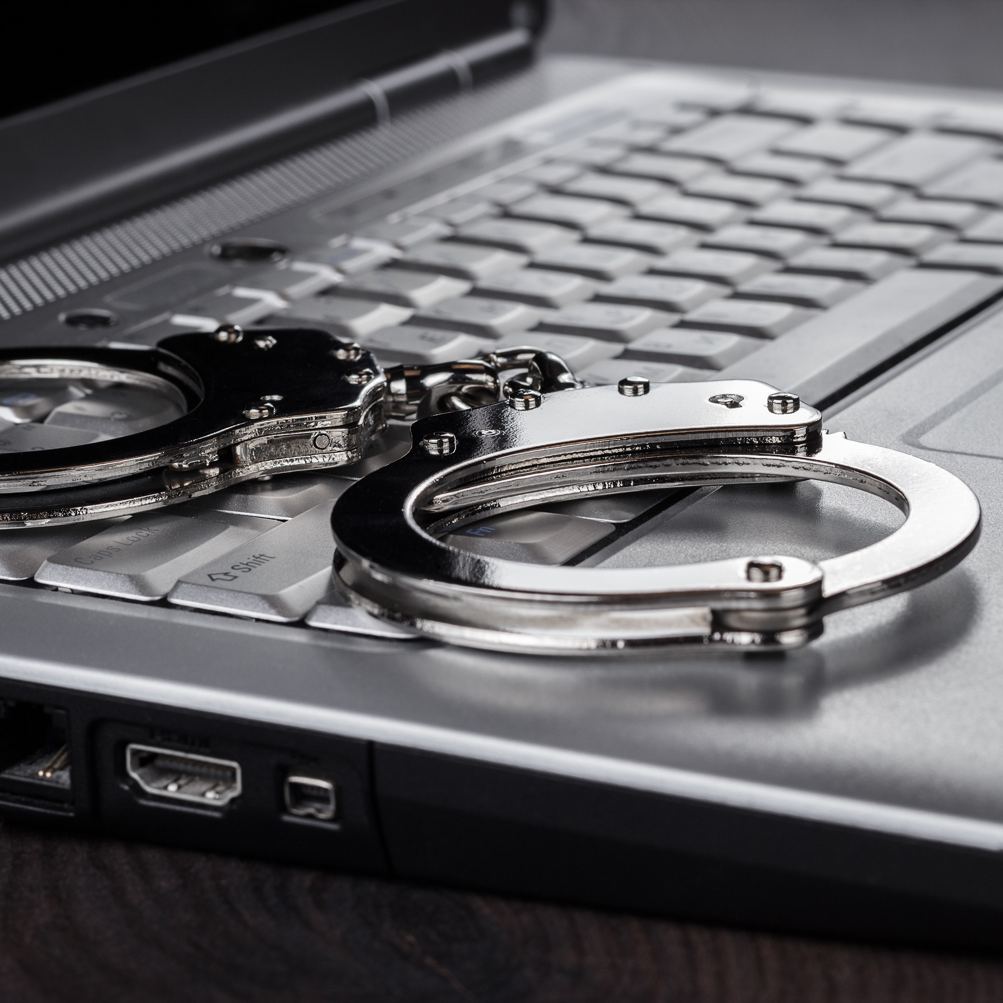 Handcuffs On Laptop Cyber Crime Concept